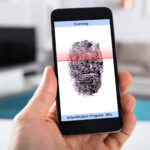 Person With Mobile Phone Scanning Fingerprint